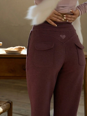 Close-up of grape purple fleece sweatpants showing back pockets detail