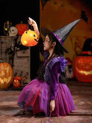 Halloween Kids Costumes featuring a purple and black witch dress with starry patterns and a tall pointed hat, holding a pumpkin lantern.