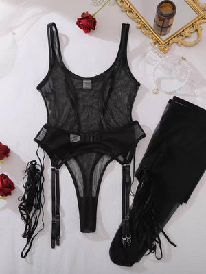 Flat lay display of the black sheer mesh bodysuit lingerie set including the garter straps, detachable stockings, and lace accessories on a white surface.