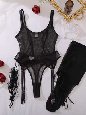 Flat lay display of the black sheer mesh bodysuit lingerie set including the garter straps, detachable stockings, and lace accessories on a white surface.