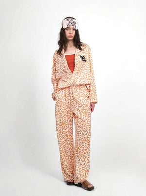 Orange leopard pajama set for women, front view of the button-up shirt