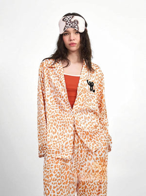 Womens leopard pajama set in orange showing the wide leg drawstring pants