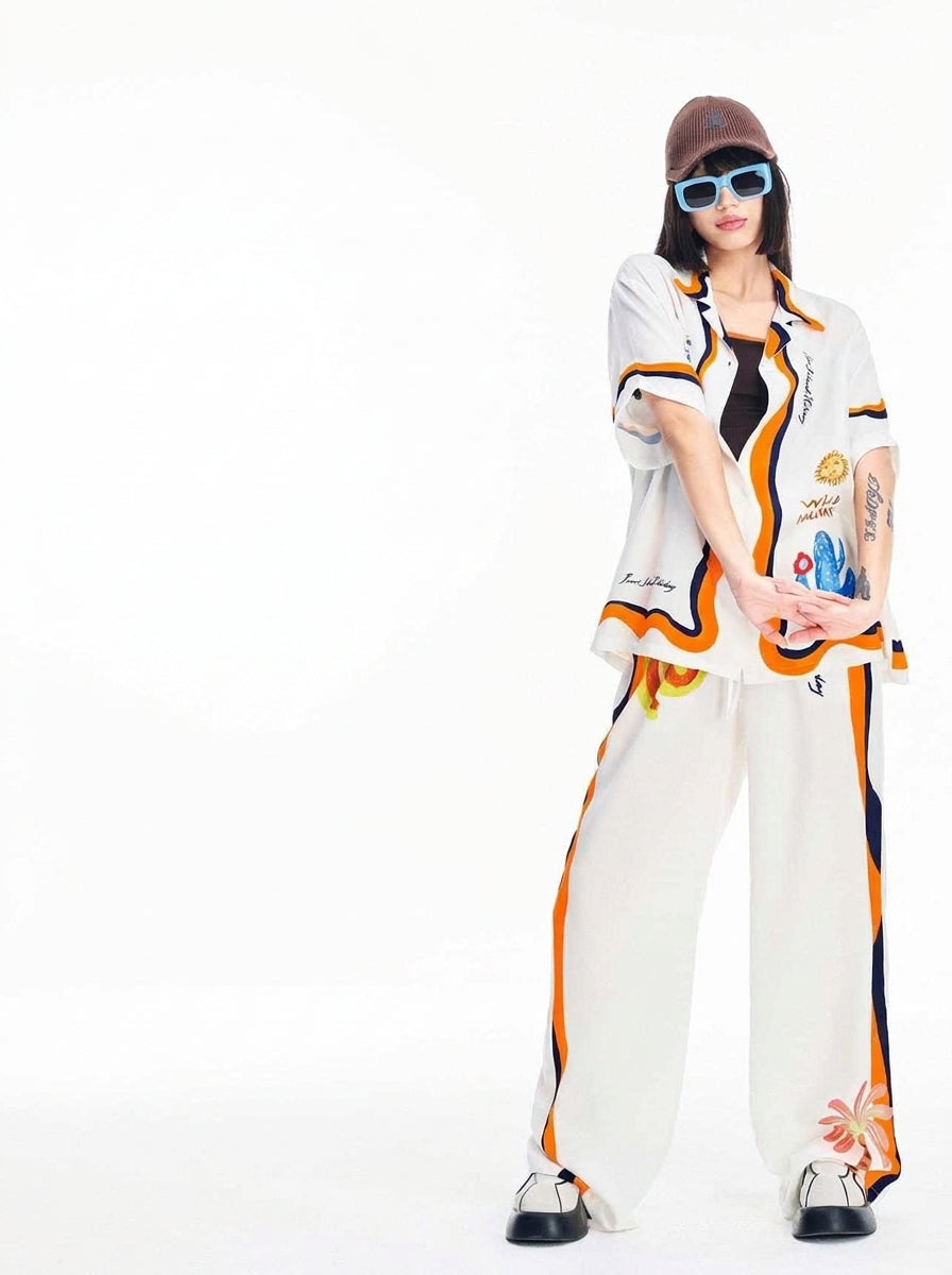 Sun and cactus motifs on the white pajama shirt of this two-piece set