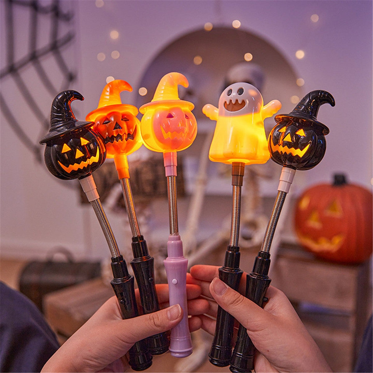 Halloween decoration glowing plastic lanterns shaped like witches, pumpkins, and ghost on hand crank sticks with black and purple handles