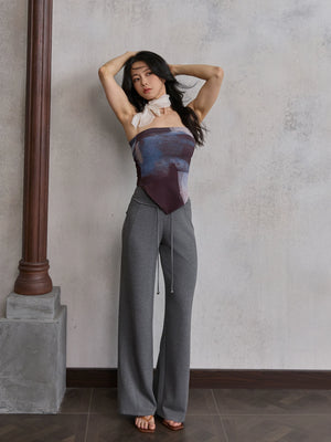 Model wearing grey straight leg sweatpants with gradient strapless top, front view