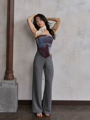 Model wearing grey straight leg sweatpants with gradient top, front view
