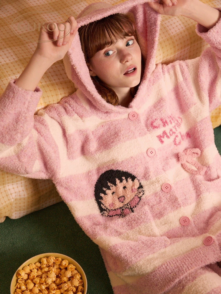 Fleece hooded loungewear set in pink, overhead view of model lying down