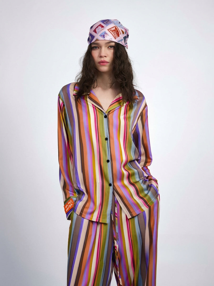 Multicolor striped pajama set seen from the front, notched collar shirt with drawstring pants