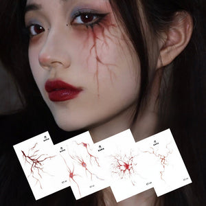 Halloween face stickers with blood vessel patterns in red, applied on cheek for a spooky red vein effect.